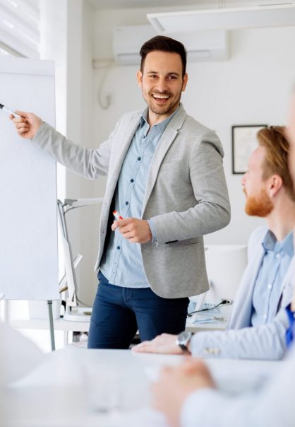 Business plan explained on flipchart by CEO to employees